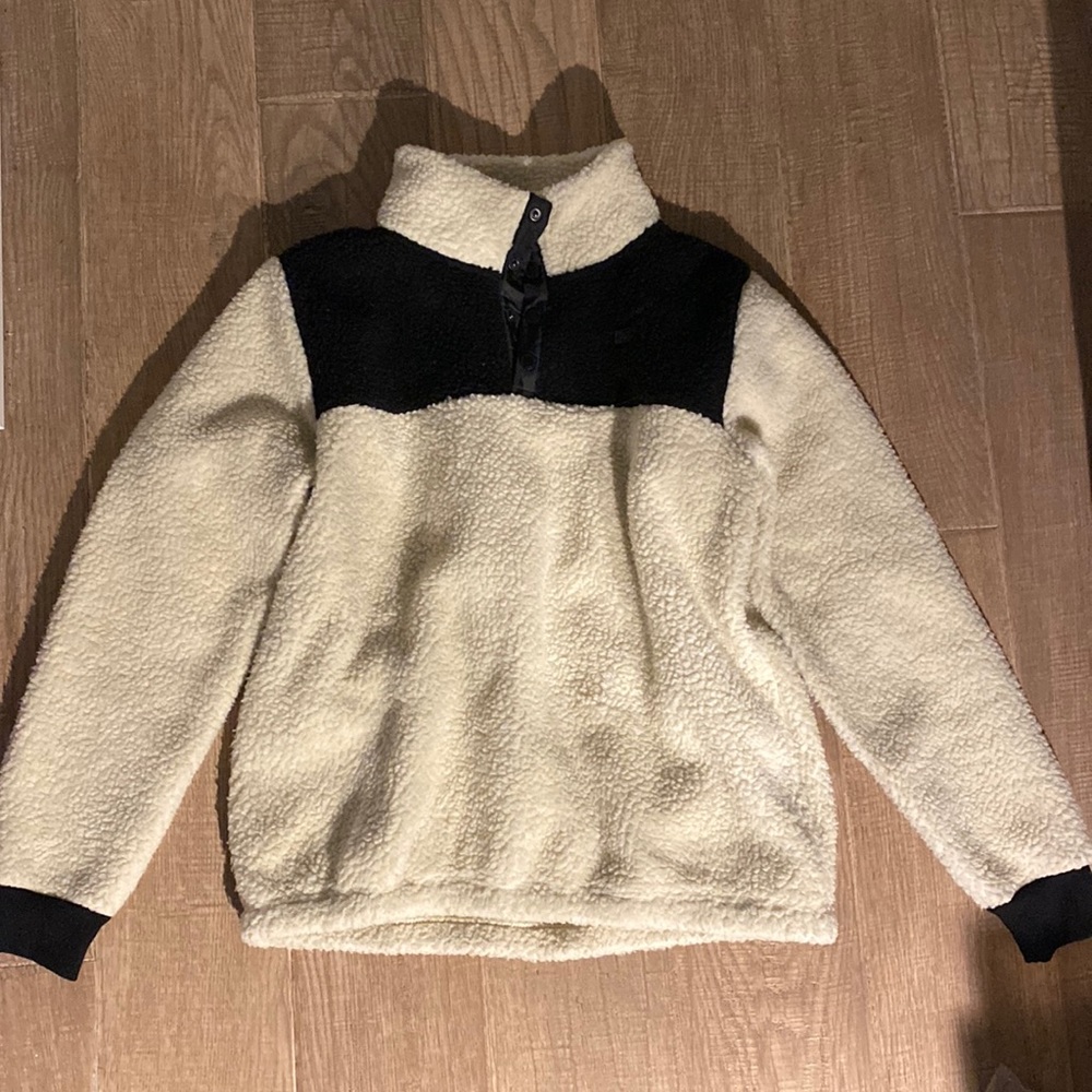 A large black and beige teddy jacket from Salty Crew